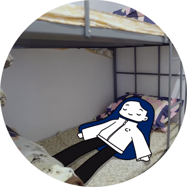 Cartoon character with blue hair lying calmly on the bottom bunk bed with patterned bedding.