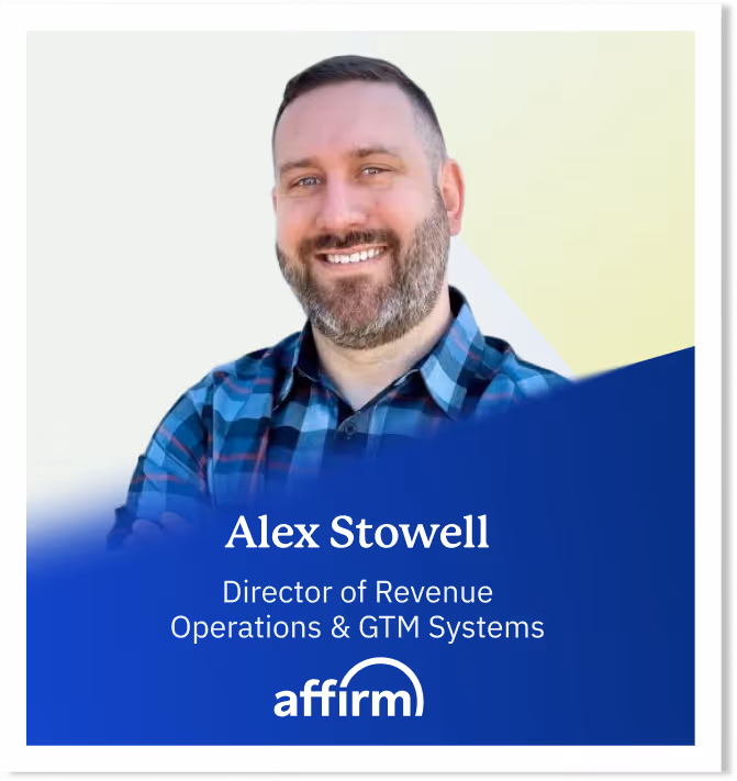 Portrait of Alex Stowell, Director of Revenue Operations & GTM Systems at Affirm, smiling and wearing a blue plaid shirt.