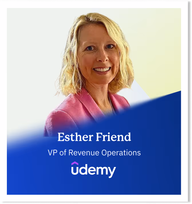 Portrait of Esther Friend, VP of Revenue Operations at Udemy, smiling and wearing a pink blazer.
