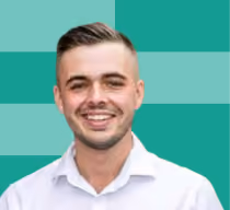 Smiling young man with short hair and a white shirt against a teal-striped background.