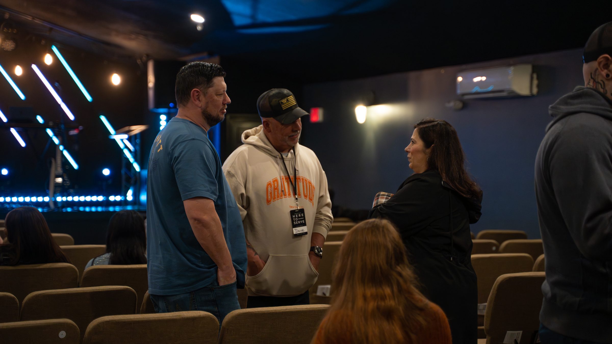 Church members talking in the aisle of the Granite United auditorium before a service