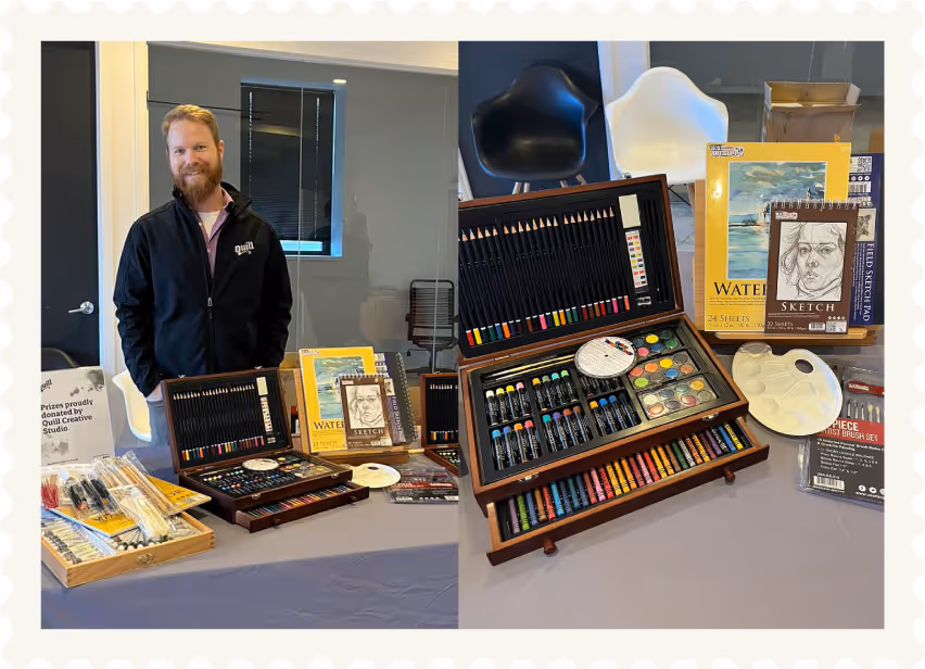 Quill tradeshow table displaying art prizes for the Love Shouldn't Hurt art show at Christine Ann Domestic Center