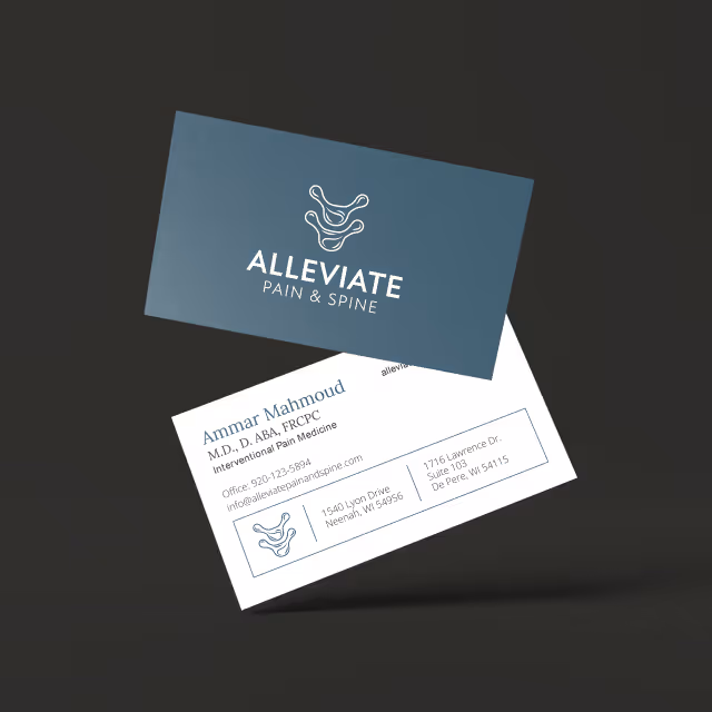 Alleviate Pain & Spine business cards on dark background
