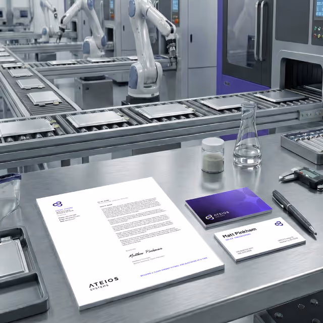 Ateios stationery items sitting on a metal surface in front of the production line