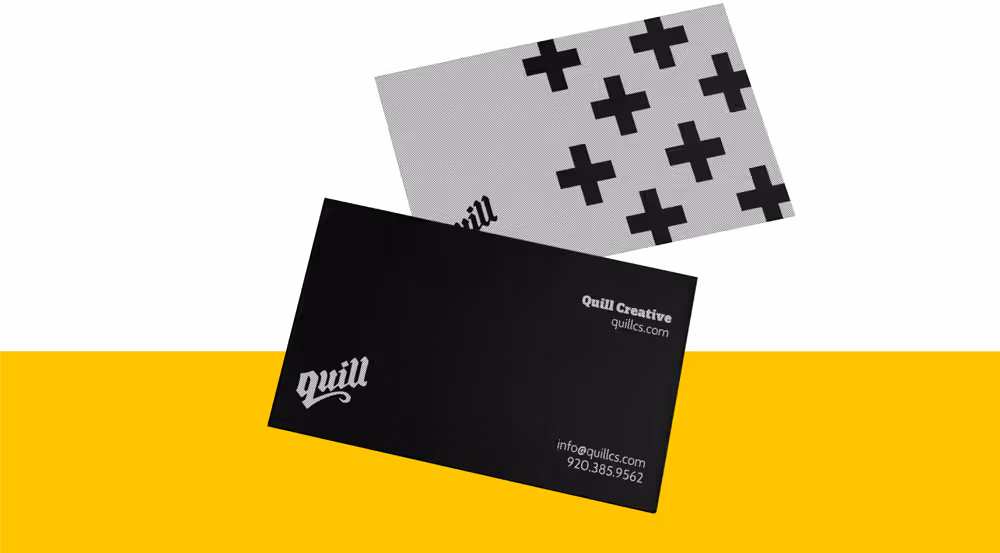 Two business cards, one black with white text showing Quill Creative and contact info, and one gray with bold black plus signs and partial 'Quill' text.