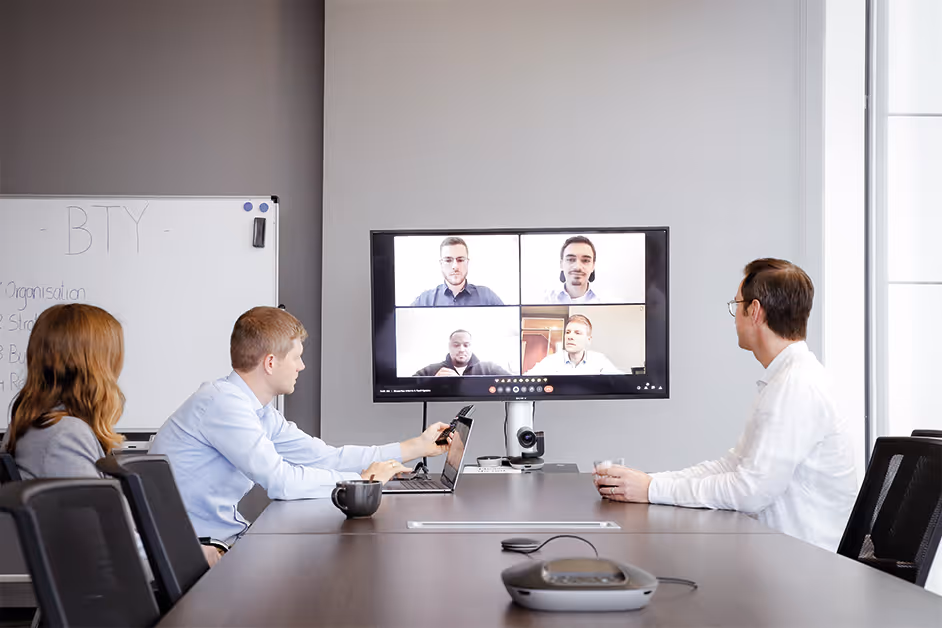 A group of people sitting around a conference table