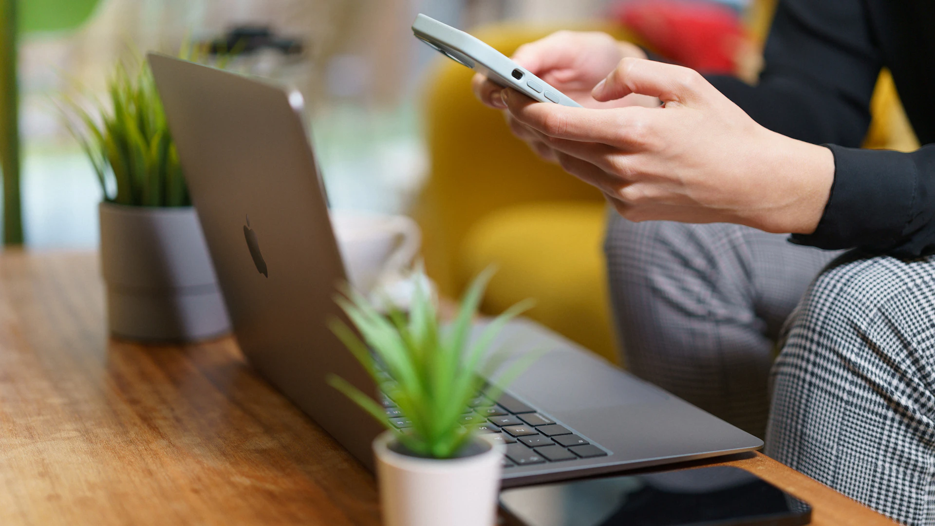 using smartphone and laptop home living room interior