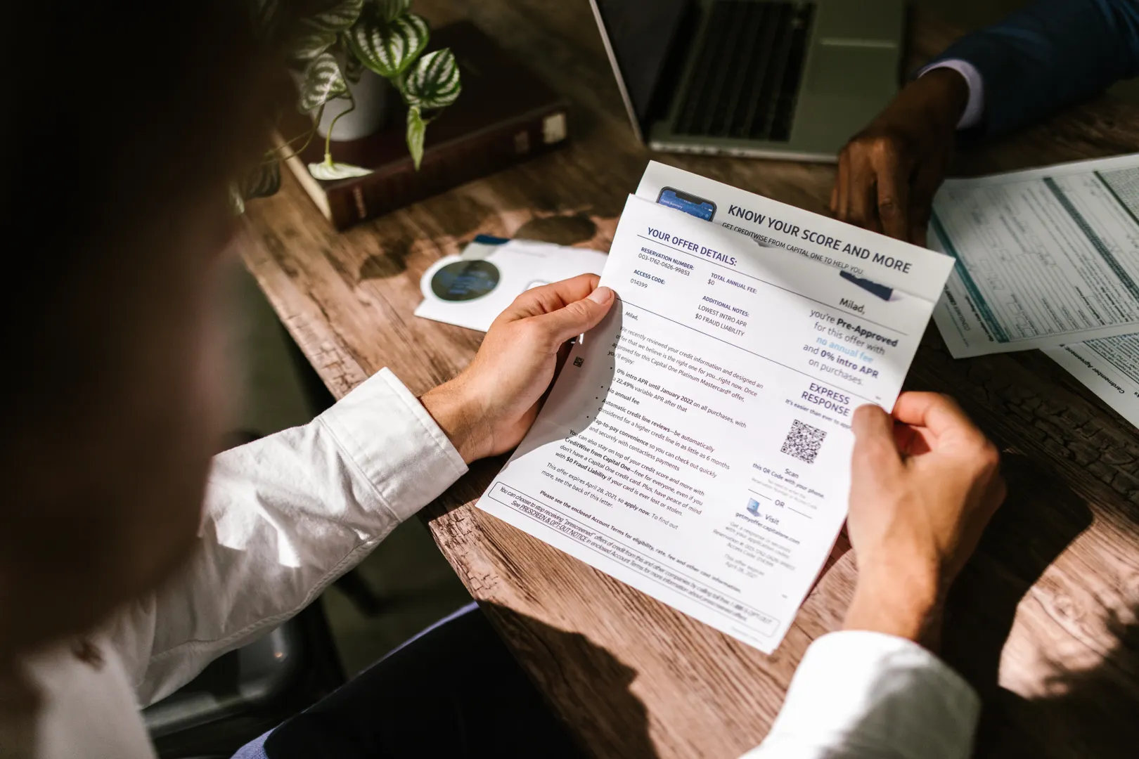 Over-the-shoulder view of a person reviewing a credit score report