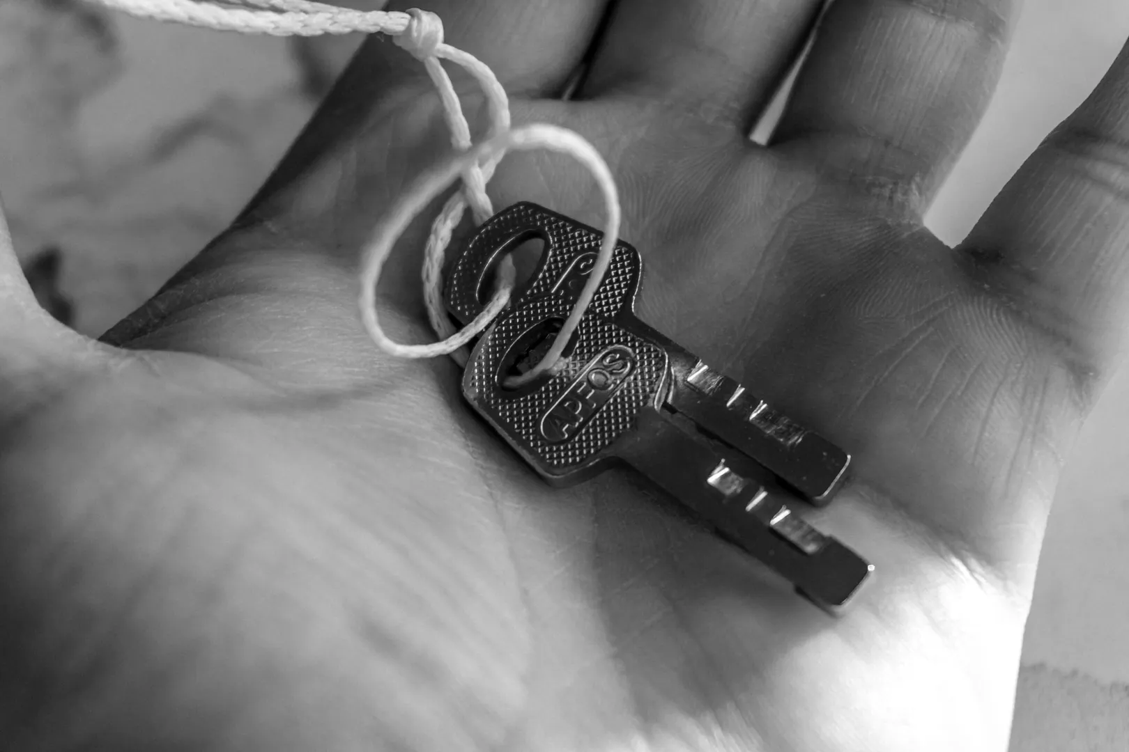 Two metal keys resting in a person's open palm