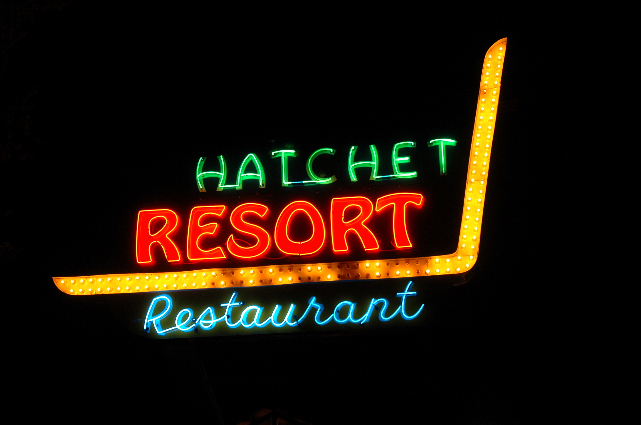 Neon Hatchet Resort sign.