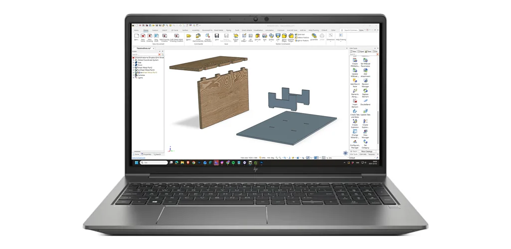 Bärbar dator med IRONCAD som visar tappar och hål i laserskurna fixturdelar, med IC Mechanical-katalogen till höger