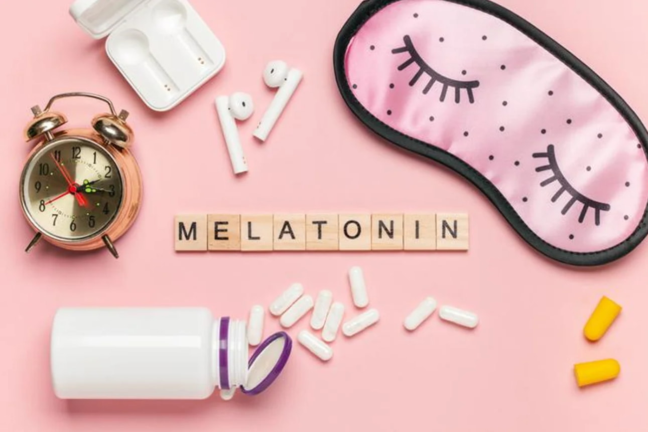 Melatonin supplements and sleep aid products arranged on a wooden surface, promoting better sleep and relaxation.