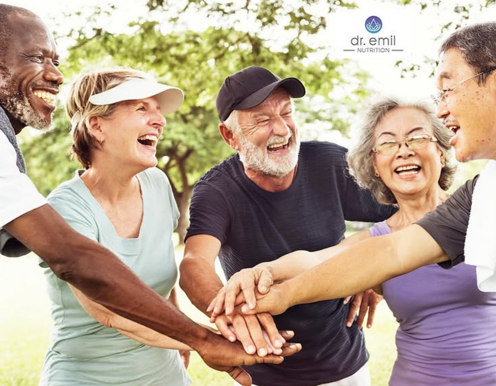 A group of older adults holding hands while enjoying a sunny day in the park. 