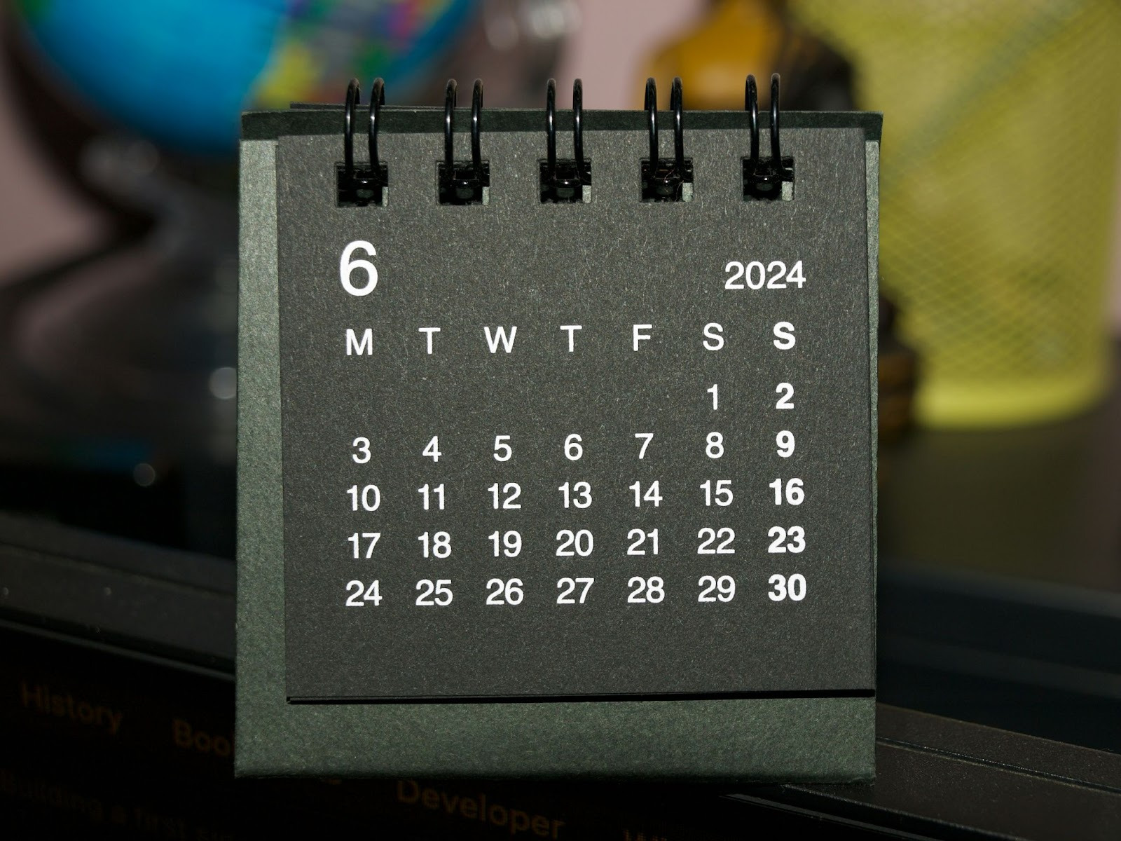 A calendar featuring a black background with a prominent white date displayed clearly.  