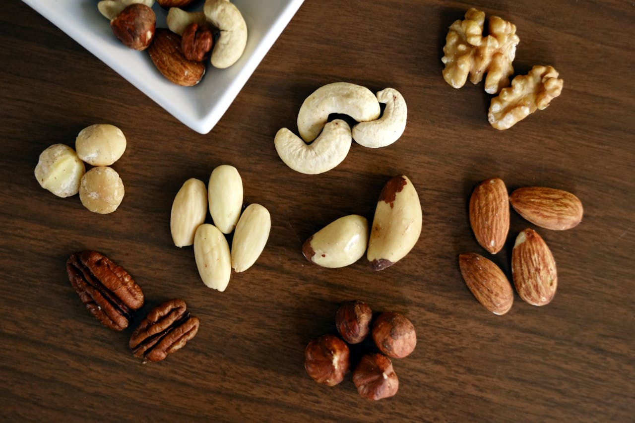 a variety of nuts and seeds arranged on a table