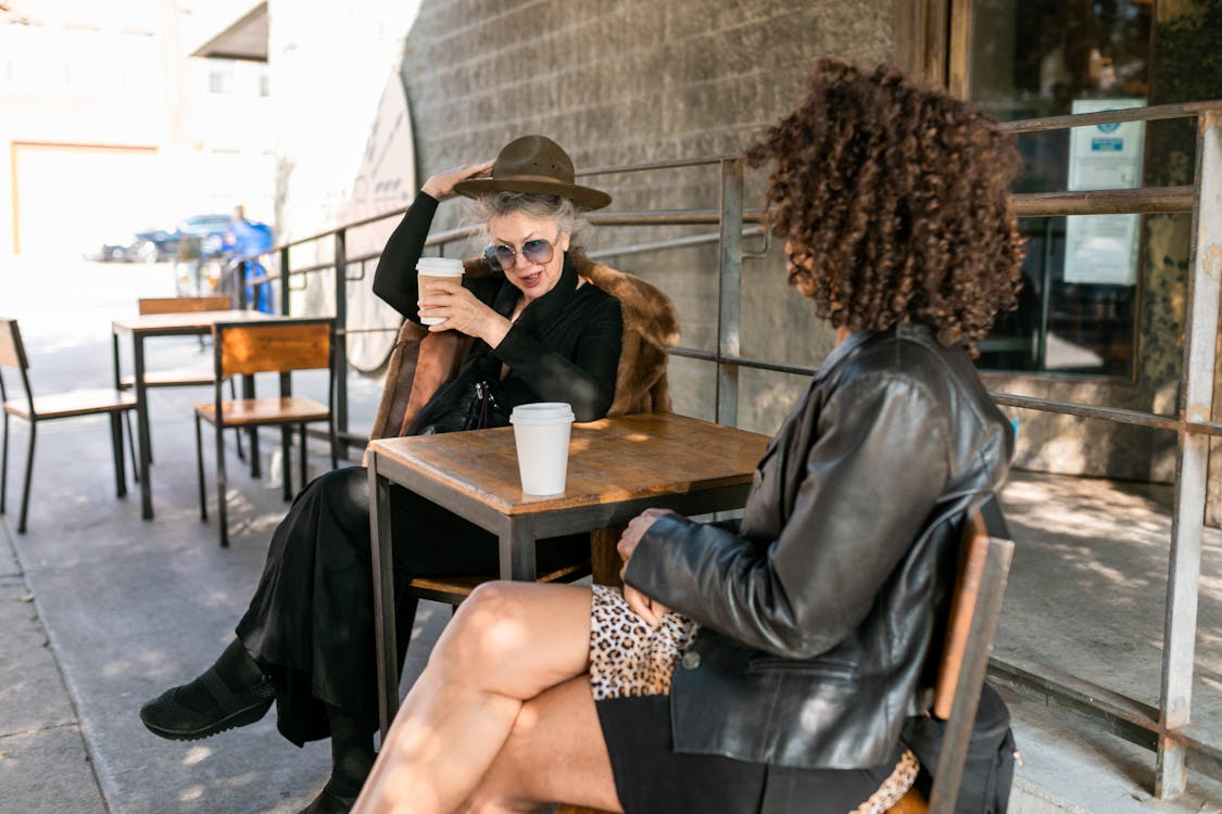 two women discussing does collagen help with menopause? over coffee at a cute shop
