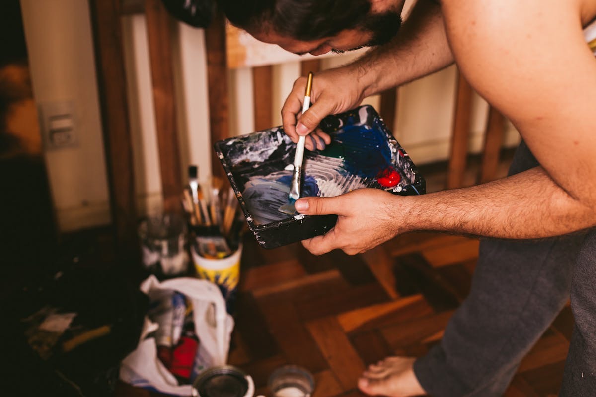 artist mixing paint with a brush