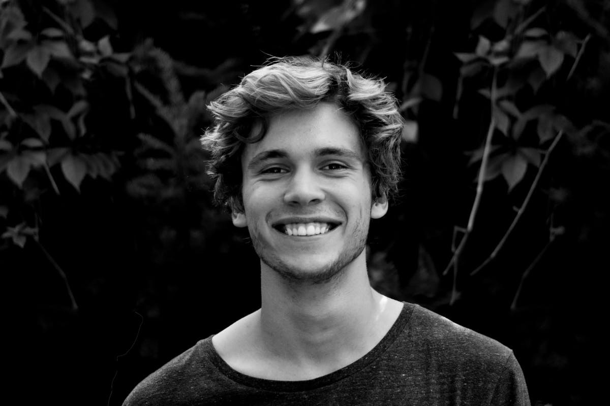 black and white photo of a smiling young man