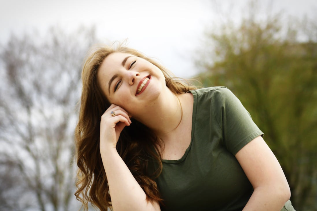 happy woman sitting outside in the sunshine