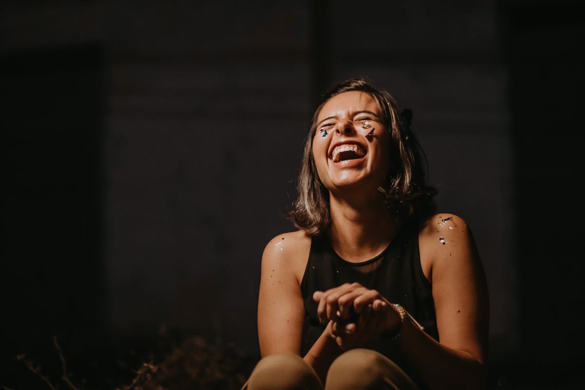 woman dusted in confetti laughing