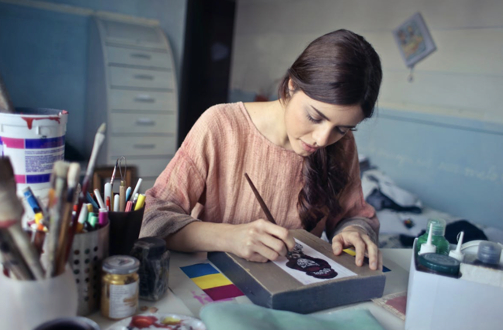 painter bent over her working during a burst of inspiration