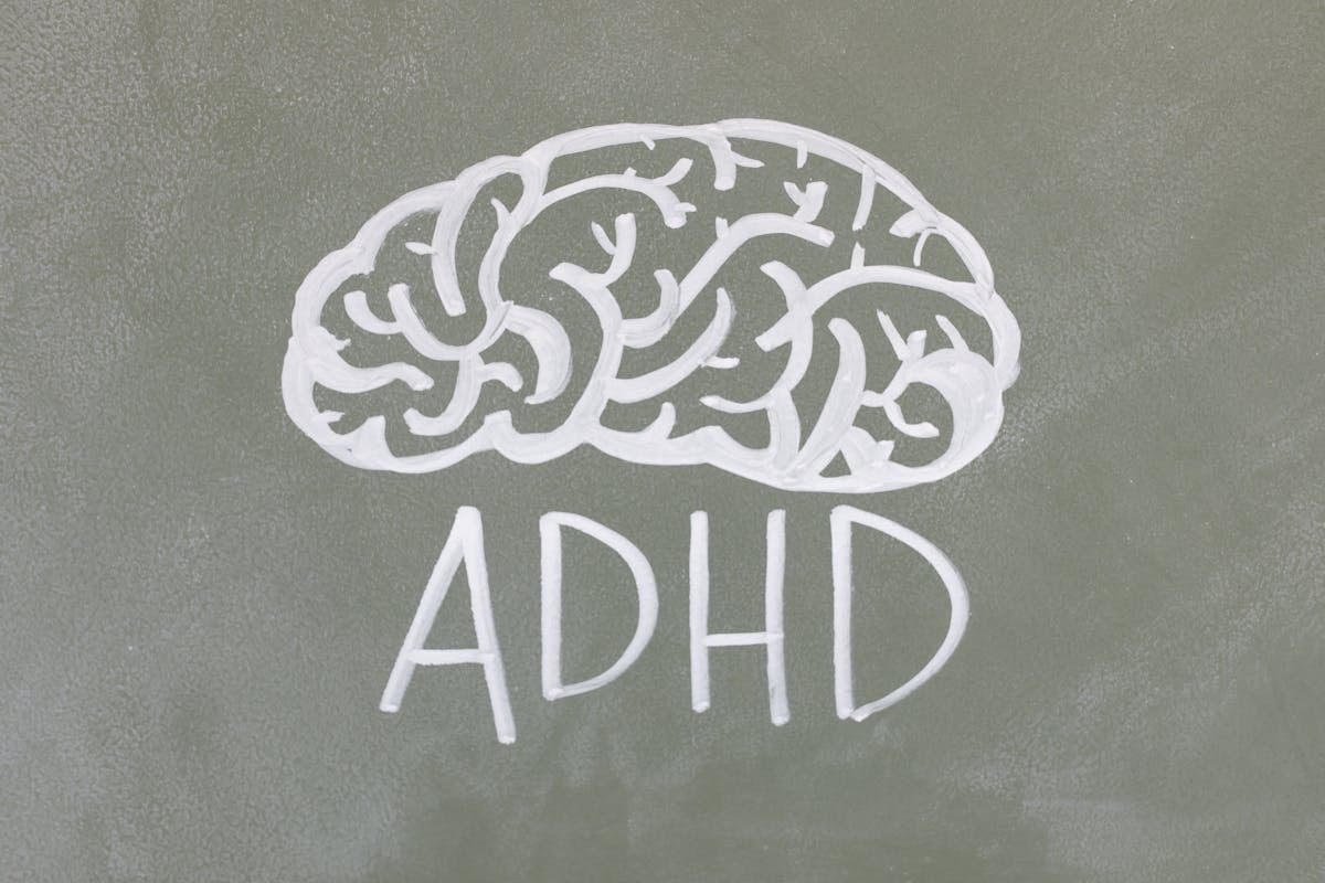 brain and the word ADHD drawn on a chalkboard
