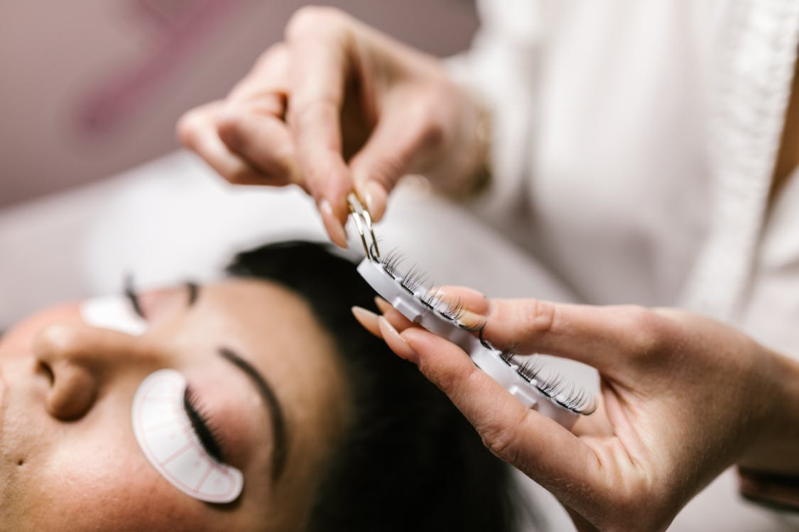 woman having her eyelashes professionally done