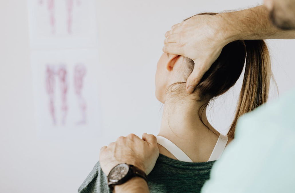 woman having her neck cracked by a chiropractor to address joint pain