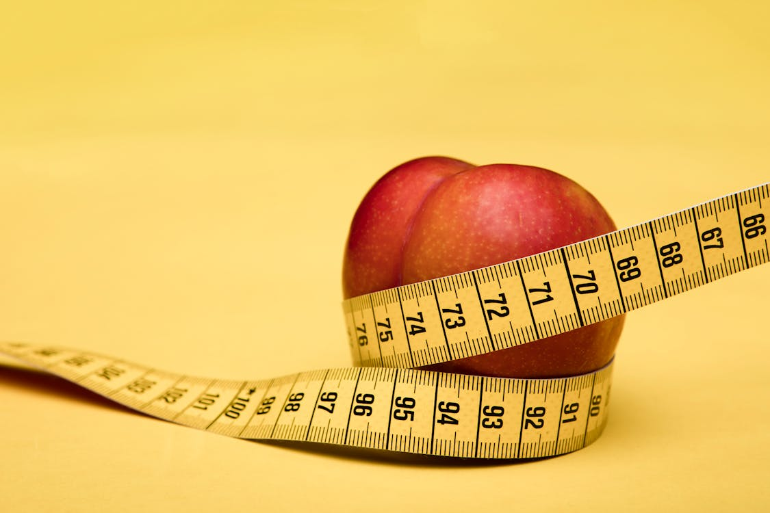 flexible measuring tape wrapped around an apple
