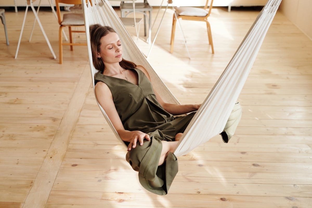 woman relaxing in a hammock looking calm and at peace