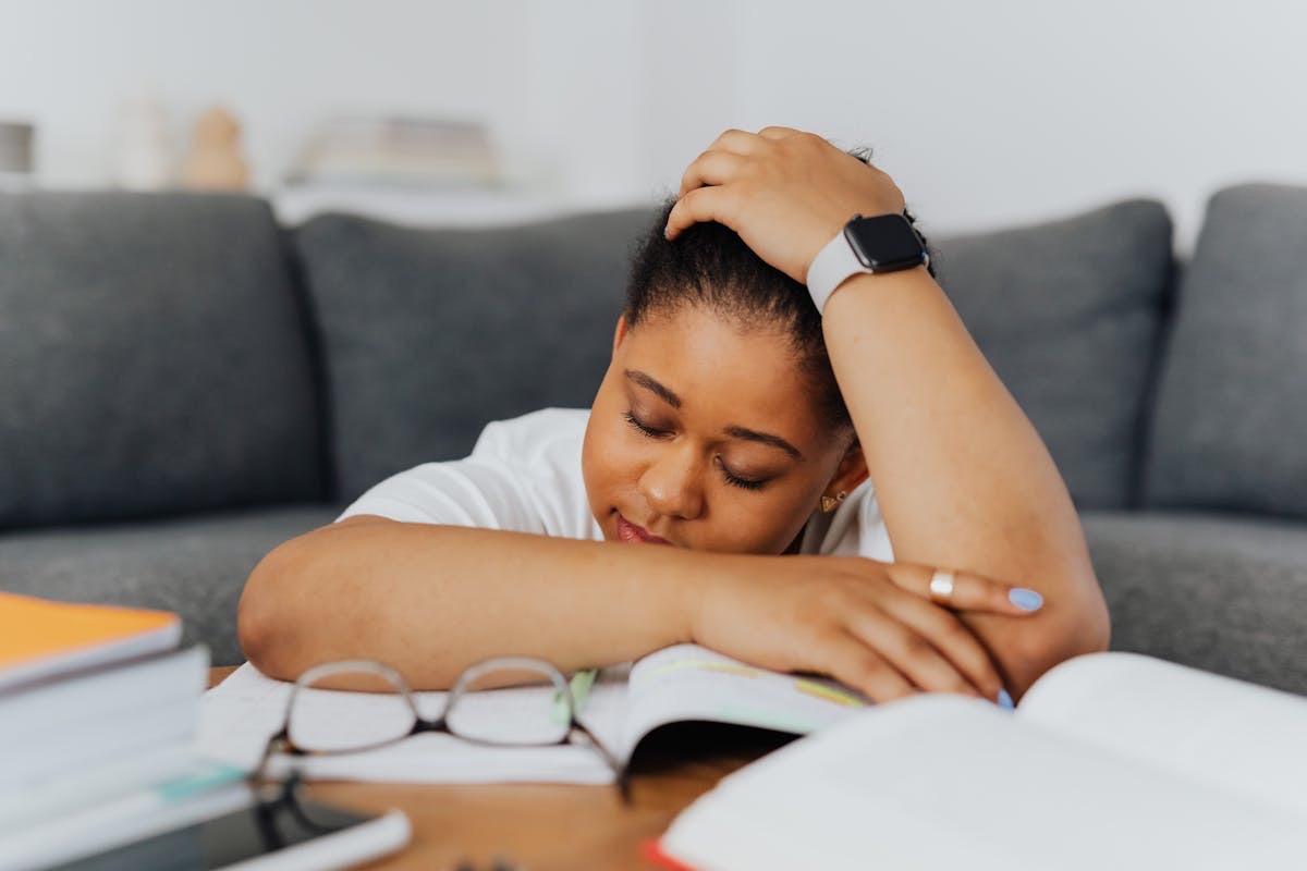 sleepy woman leaning on her coffee table
