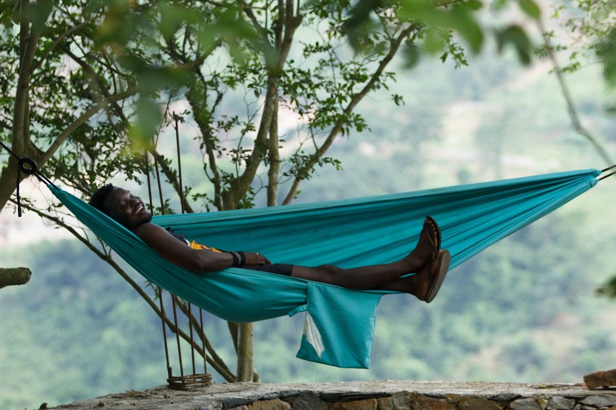 relaxed man taking a nap in a hammock on a nice summer day