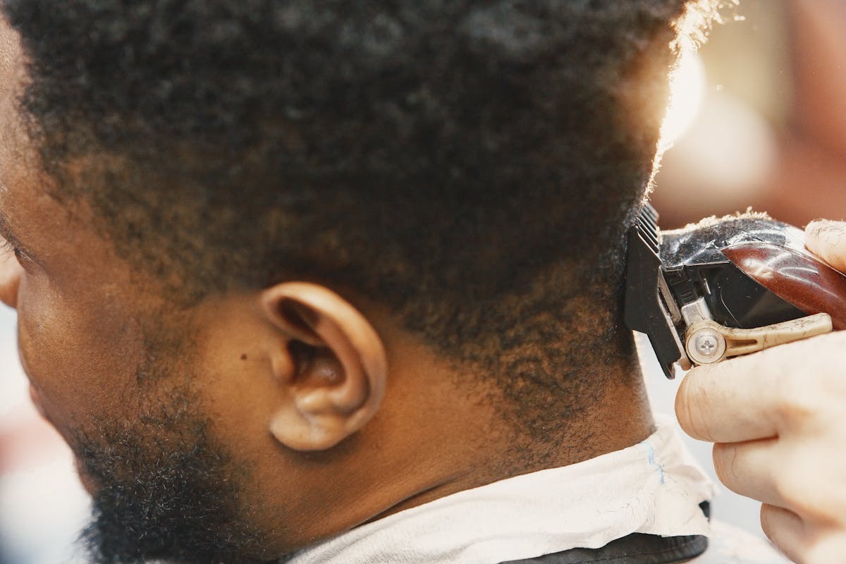 man in the barber's chair having his healthy, flake-free hair trimmed