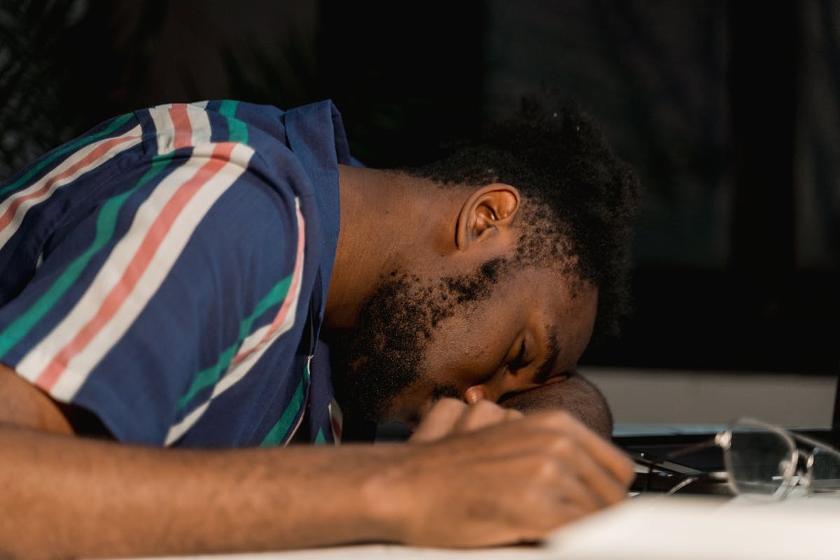 man resting his head on his arm because he's exhausted