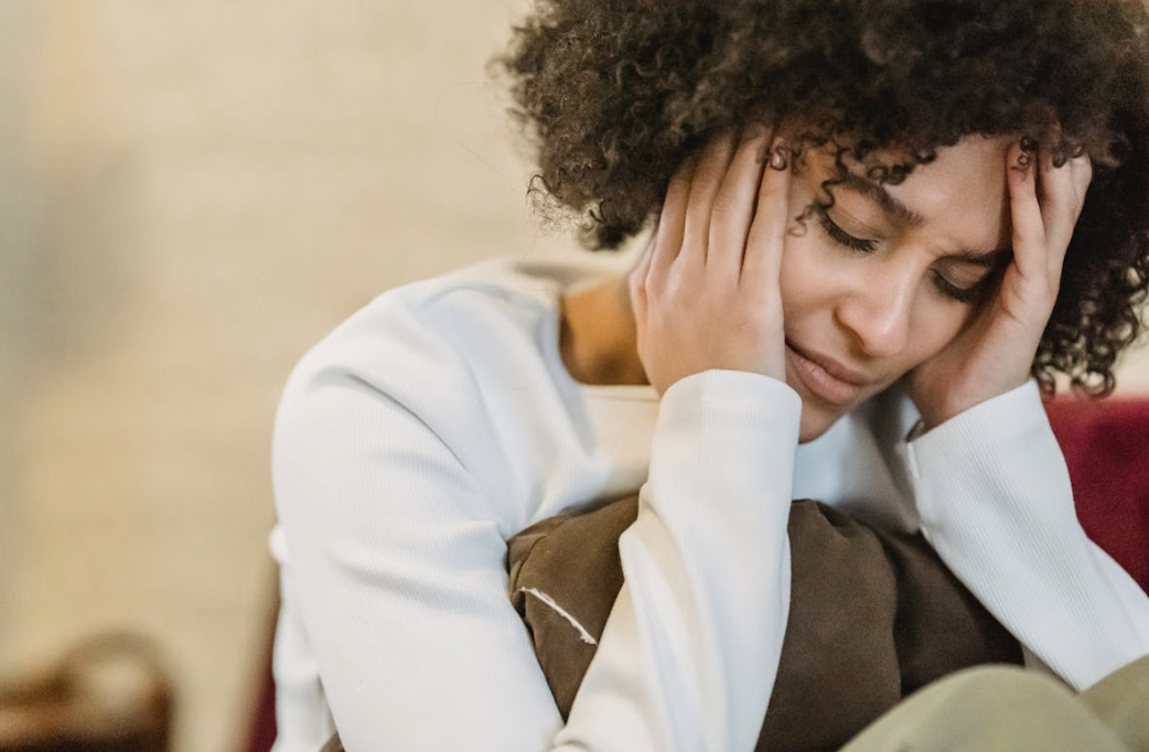 woman suffering from anxiety and depression with her head in her hands