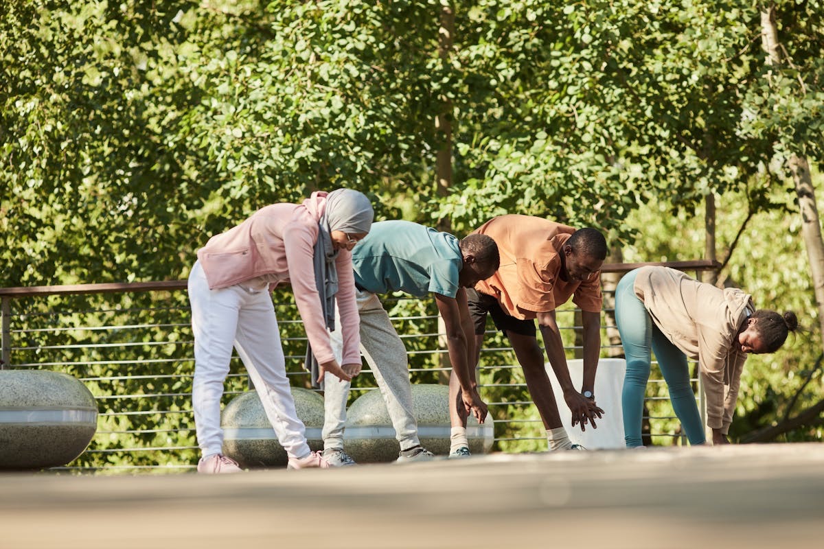 family conducting stretches before a run in the park