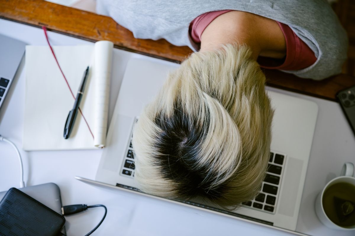 student falling asleep on their keyboard