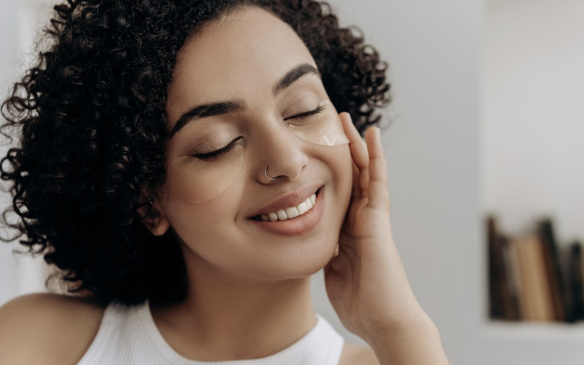 woman wearing under eye patches as a part of her skincare routine