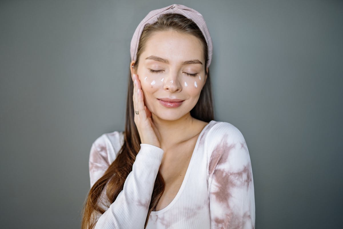 woman with dots of serum sprinkled across her cheeks as part of skincare routine