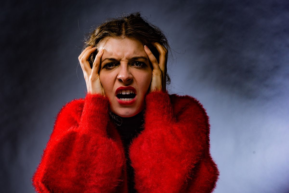 woman in a red sweater having an anxiety attack and wishing for a natural remedy for her anxiety