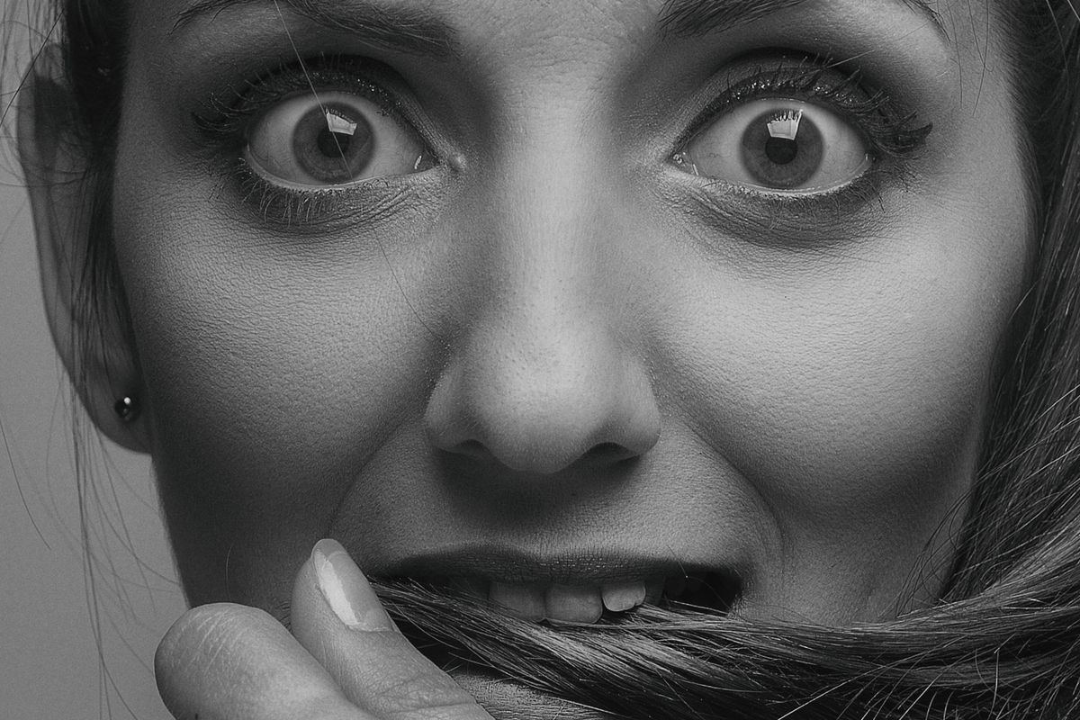 close up of a woman's face with wide, anxious eyes