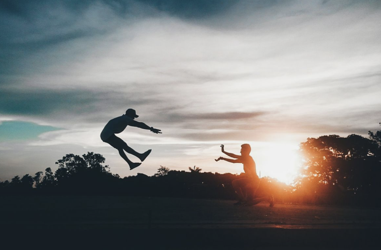 figures leaping energeticlaly in silhouette demonstrating youthful vitality
