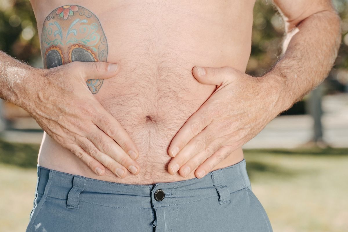 man holding his upset stomach