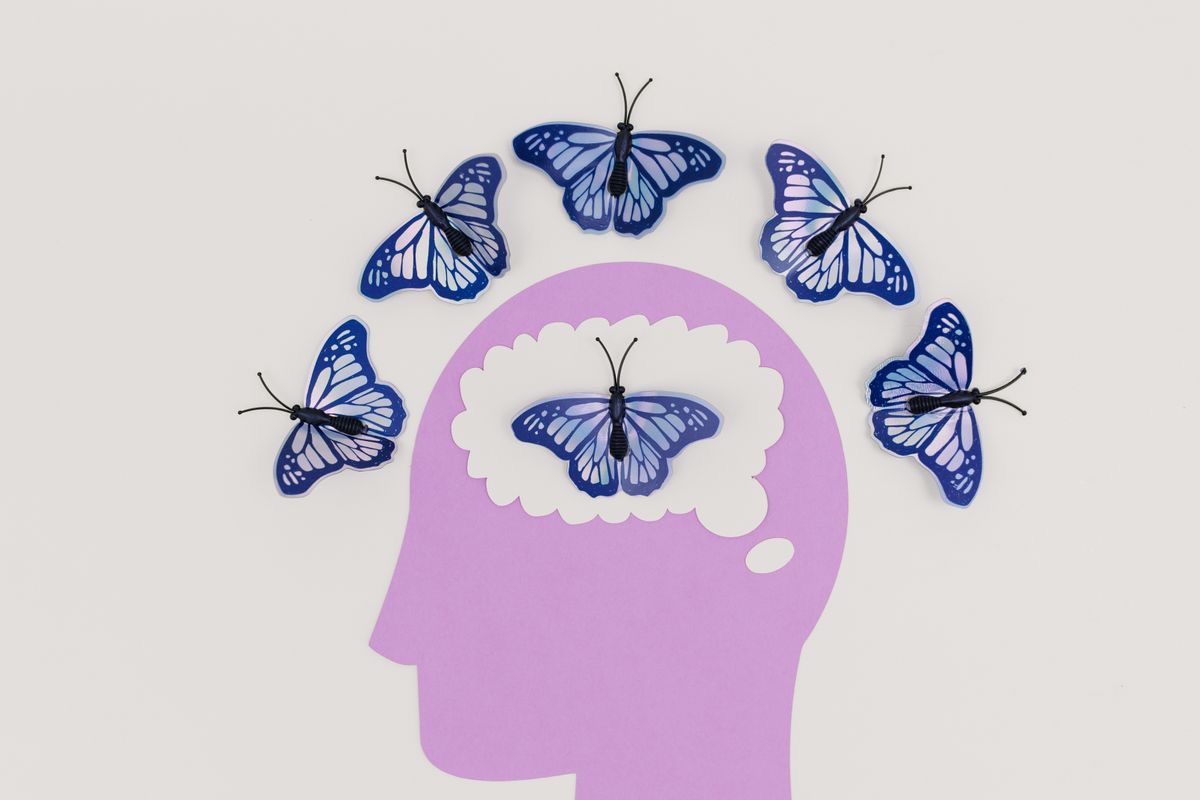 drawing of a head surrounded by butterflies