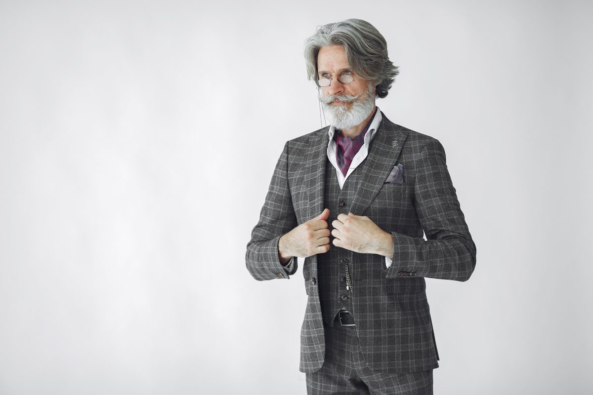 older gentleman wearing a tasteful gray suit