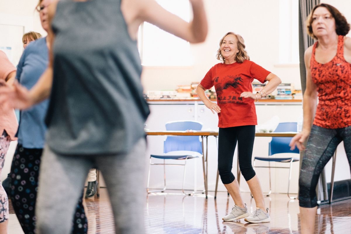 older women smiling as they participate in a dance class thanks to the benefits of nmn