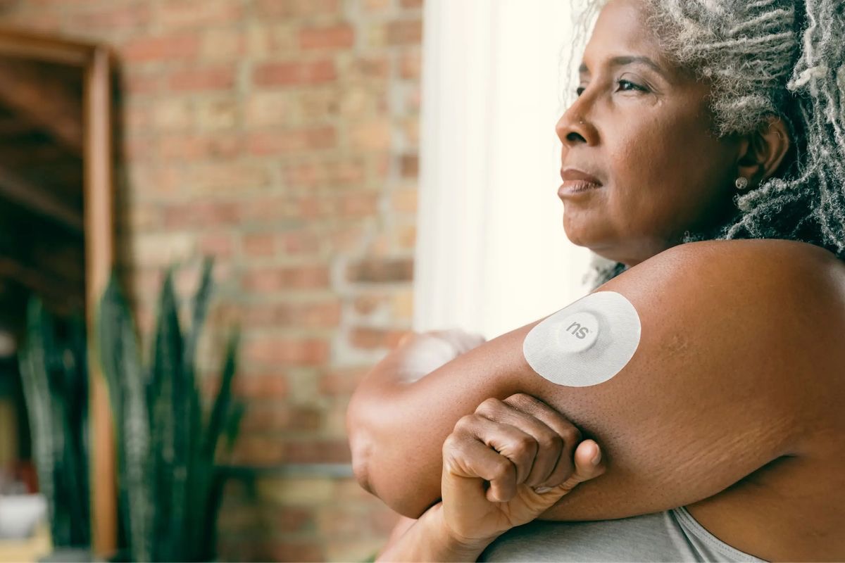 woman wearing an insulin pump to manage her blood glucose levels