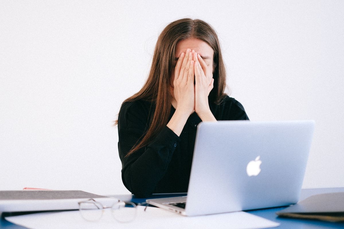 woman stressing out in front of her latpop