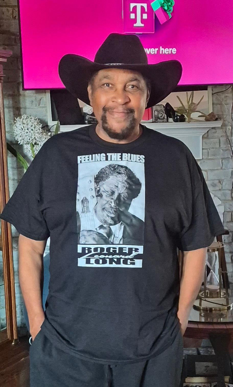 B. B. King Roger Leonard Long Portrait Art T-shirt. This high quality original t-shirt is truly wearable art. It features an exclusive portrait from artist Roger Leonard Long.
- 4.5 oz., 100% preshrunk ring spun cotton
- 90% cotton 10% polyester
- ¾" rib knit collar
- Double-needle stitched sleeves and bottom hem
Available in sizes XS-2XL