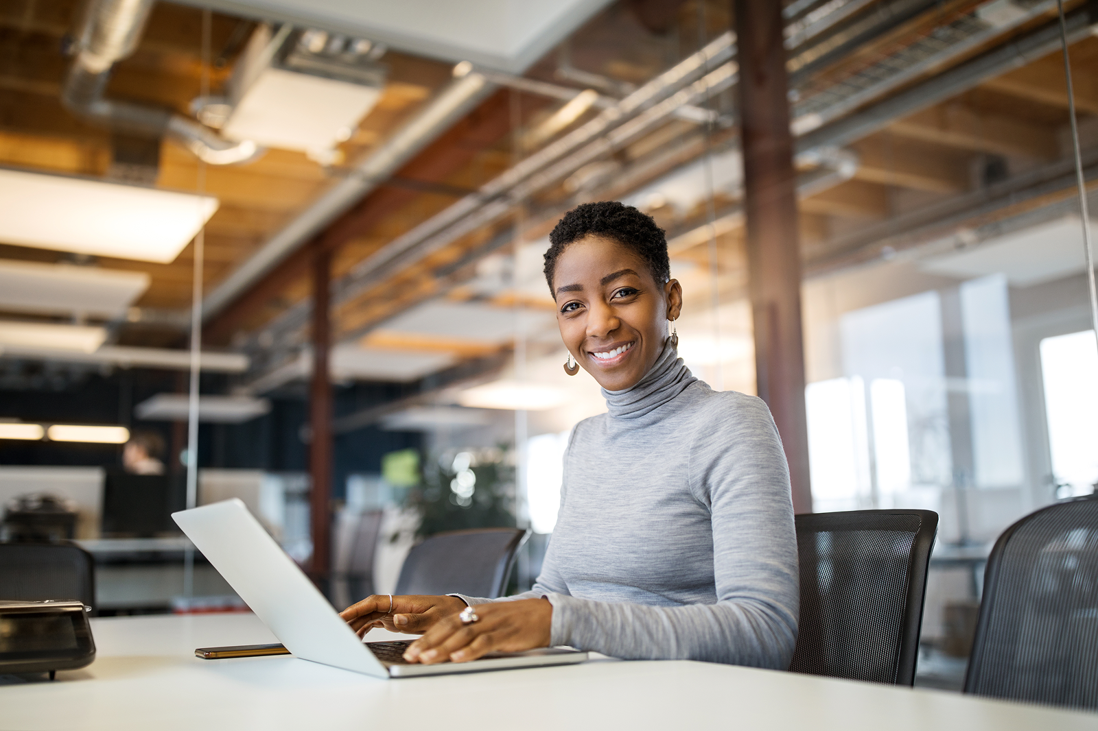 Finance professional working on a laptop in a modern office, representing decision-makers evaluating global mental health benefits vendors.